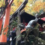 Running fox statue at small shrine at Fushimi Inari Shrine