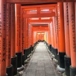 many red torii at small shrine at Fushimi Inari Shrine